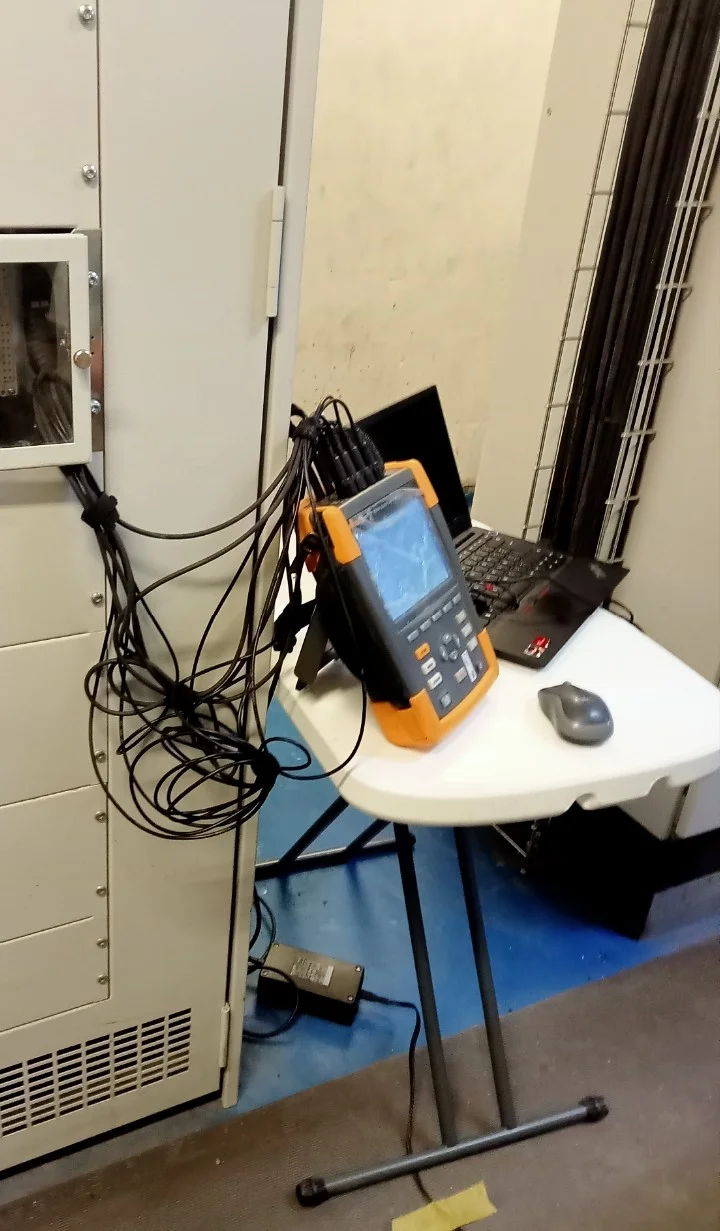 Analizador conectado a tablero de control junto a laptop en sitio de medición